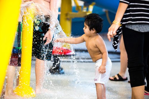 MIKAELA MACKENZIE / WINNIPEG FREE PRESS
Agam Sembi, one, tests out the water at the citys first indoor splash pad at Seven Oaks Pool in Winnipeg on Thursday, March 28, 2019. 
Winnipeg Free Press 2019.