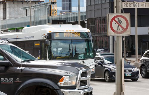 MIKE DEAL / WINNIPEG FREE PRESS
A Winnipeg Transit bus travels through the intersection of Portage Avenue and Main Street Thursday afternoon.
190328 - Thursday, March 28, 2019.