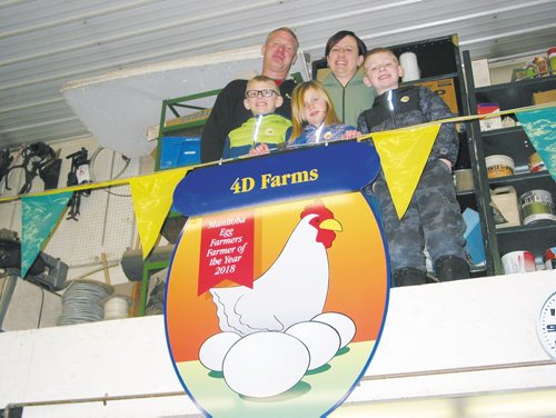 Canstar Community News March 25, 2019 - Eric and Sandra Dyck are shown with their children (from left) Levi, 8, Rylee, 6, and Jacob, 10, standing behind the award they received from the Manitoba Egg Producers. (ANDREA GEARY/CANSTAR COMMUNITY NEWS)