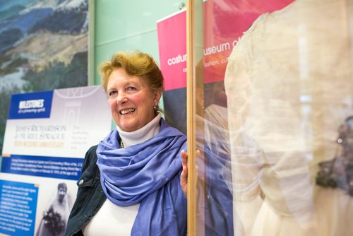 MIKAELA MACKENZIE / WINNIPEG FREE PRESS
Margaret Mills, board member of the Costume Museum, poses for a portrait with the Muriel Richardson dress on display in the Richardson Building in Winnipeg on Monday, April 1, 2019.  For Cassidy Dankochik story.
Winnipeg Free Press 2019.