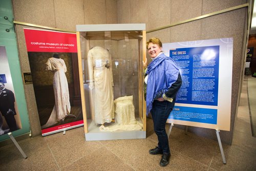 MIKAELA MACKENZIE / WINNIPEG FREE PRESS
Margaret Mills, board member of the Costume Museum, poses for a portrait with the Muriel Richardson dress on display in the Richardson Building in Winnipeg on Monday, April 1, 2019.  For Cassidy Dankochik story.
Winnipeg Free Press 2019.