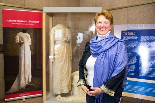 MIKAELA MACKENZIE / WINNIPEG FREE PRESS
Margaret Mills, board member of the Costume Museum, poses for a portrait with the Muriel Richardson dress on display in the Richardson Building in Winnipeg on Monday, April 1, 2019.  For Cassidy Dankochik story.
Winnipeg Free Press 2019.