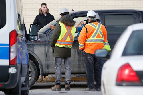 JOHN WOODS / WINNIPEG FREE PRESS
Workplace Health and Safety officials talk to a driver as they investigate at the scene of a fatal pedestrian/truck collision in the Garden City Shopping Centre parking lot in Winnipeg Monday, April 1, 2019.