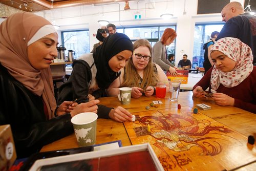 JOHN WOODS / WINNIPEG FREE PRESS
Suhad Bakri, left, with her niece Mei and daughter Lina play a game with Carleen Bezdek at Across The Board Game Cafe´ in Winnipeg Monday, April 1, 2019. Winnipegs Muslim Community and Winnipegs wider community come together to Play for Peace in support of recent events in Christchurch, New Zealand.
