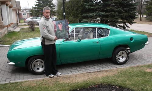 Jim Seggie holding pic of son Corp Mike Seggie killed in Afghanistan. with 1968 Plymouth Barracuda being restored. willy story PAUL WILLIAMSON / winnipeg free press