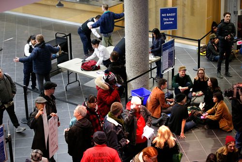 JOHN WOODS / WINNIPEG FREE PRESS
People take part in a sit-in protest at Millennium Library in Winnipeg Tuesday, April 2, 2019. About two hundred people gathered to protest the use of security checks to enter the library.