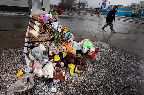 PHIL HOSSACK / WINNIPEG FREE PRESS - A pedestrian makes his way near the memorial for  Galila Barakiel at the crosswalk where she and her mother Genet were struck. The flowers and stuffed animals have been moved from the crosswalk signal post back to a light standard farther away from the street. See Rollason's story.- April 4, 2019.