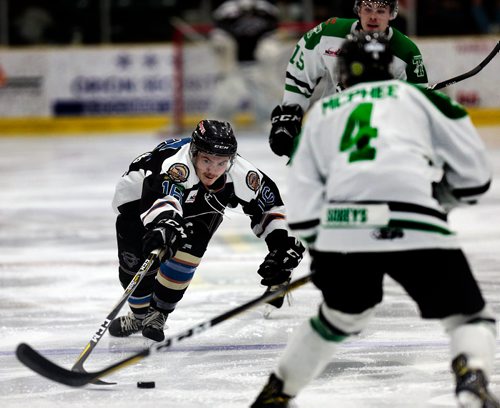 PHIL HOSSACK / WINNIPEG FREE PRESS - Swan Valley Stampeder #16 Josh Tripp reaches for the puck flanked by Portage terriers #4 Caelan McPhee and #15 Joey Moffatt  Friday night at Stride Place in Portage la Prairie. See Mike Sawatzsky story. -  April 5, 2019.