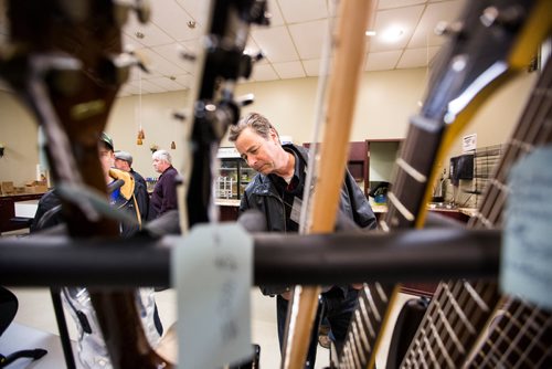 MIKAELA MACKENZIE / WINNIPEG FREE PRESS
Kirk Esau checks out guitars at the Manitoba Guitar Traders Show & Sale in Winnipeg on Saturday, April 6, 2019. 
Winnipeg Free Press 2019.