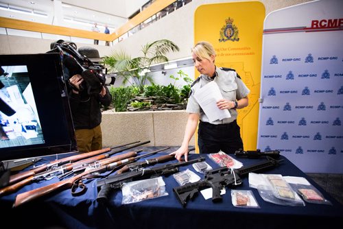 MIKAELA MACKENZIE / WINNIPEG FREE PRESS
Corporal Julie Courchaine points out firearms and cash seized in Oakbank at the RCMP D Division Headquarters in Winnipeg on Monday, April 8, 2019.
Winnipeg Free Press 2019.