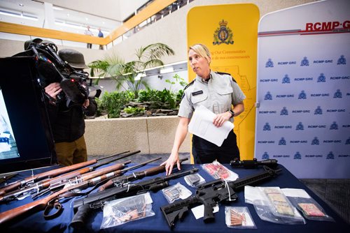 MIKAELA MACKENZIE / WINNIPEG FREE PRESS
Corporal Julie Courchaine points out firearms and cash seized in Oakbank at the RCMP D Division Headquarters in Winnipeg on Monday, April 8, 2019.
Winnipeg Free Press 2019.