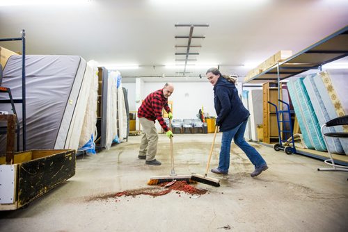 MIKAELA MACKENZIE / WINNIPEG FREE PRESS
Armando Lourenco (left) and Odette Gonzalez sweep the floor at the Hands of Hope, an organization that gives away basic household goods and furniture to families, in the North End of Winnipeg on Tuesday, April 9, 2019. 
Winnipeg Free Press 2019.