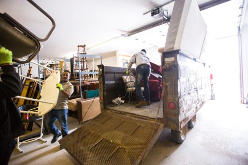 MIKAELA MACKENZIE / WINNIPEG FREE PRESS
Volunteers Solomon Temesgen (left) and Kidane Temlso load up the trailer at the Hands of Hope, an organization that gives away basic household goods and furniture to families, in the North End of Winnipeg on Tuesday, April 9, 2019. 
Winnipeg Free Press 2019.