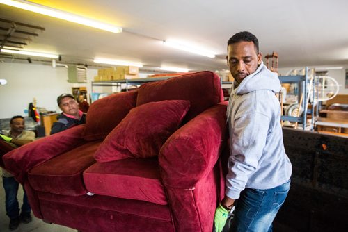 MIKAELA MACKENZIE / WINNIPEG FREE PRESS
Volunteer Kidane Temlso loads up the trailer at the Hands of Hope, an organization that gives away basic household goods and furniture to families, in the North End of Winnipeg on Tuesday, April 9, 2019. 
Winnipeg Free Press 2019.