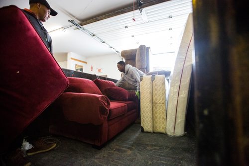 MIKAELA MACKENZIE / WINNIPEG FREE PRESS
Volunteers Hadish Tarefe (left) and Kidane Temlso load up the trailer at the Hands of Hope, an organization that gives away basic household goods and furniture to families, in the North End of Winnipeg on Tuesday, April 9, 2019. 
Winnipeg Free Press 2019.