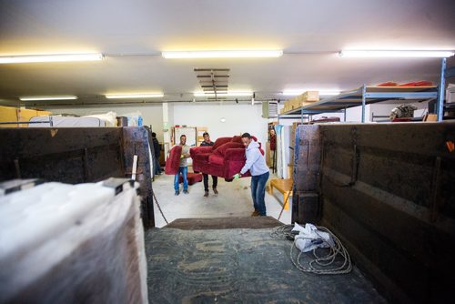 MIKAELA MACKENZIE / WINNIPEG FREE PRESS
Volunteers Solomon Temesgen (left), Hadish Tarefe, and Kidane Temlso load up the trailer at the Hands of Hope, an organization that gives away basic household goods and furniture to families, in the North End of Winnipeg on Tuesday, April 9, 2019. 
Winnipeg Free Press 2019.