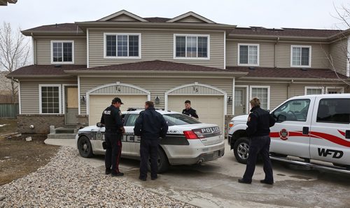 MIKE DEAL / WINNIPEG FREE PRESS
Winnipeg Fire Investigators arrive at the scene of a fatal fire in a townhome condominium complex in the 700 block of Dovercourt Drive Wednesday morning. 
190410 - Wednesday, April 10, 2019