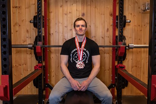 SASHA SEFTER / WINNIPEG FREE PRESS
Powerlifter Ryan Kolesar poses for a photo with his 2019 Canadian Powerlifting Union bronze medal inside of his Winnipeg home.
190410 - Wednesday, April 10, 2019.