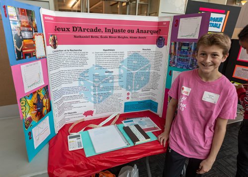 SASHA SEFTER / WINNIPEG FREE PRESS
Eighth-grader Nathaniel Betts (13) Shows off his project during the Winnipeg Schools' Science Fair on the University of Manitoba's Bannatyne campus. Translates to 'Arcade Games, unfair or chaos?'
190410 - Wednesday, April 10, 2019.