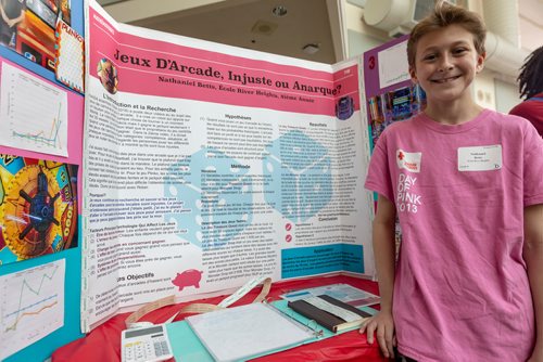 SASHA SEFTER / WINNIPEG FREE PRESS
Eighth-grader Nathaniel Betts (13) Shows off his project during the Winnipeg Schools' Science Fair on the University of Manitoba's Bannatyne campus. Translates to 'Arcade Games, unfair or chaos?'
190410 - Wednesday, April 10, 2019.