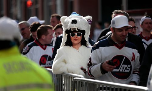 PHIL HOSSACK / WINNIPEG FREE PRESS -   Charlene Turcottte waits under her polar bear head in the lineup to get into the Jets whiteout street party on Donald Street venue Wednesday. See story. - April 10, 2019.