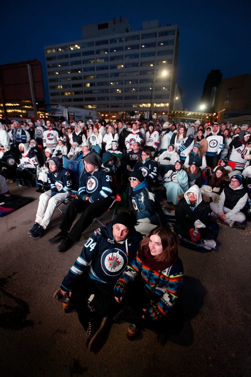 PHIL HOSSACK / WINNIPEG FREE PRESS - Winnipeg Jet Fans keep an eye on the action thanks to giant monitors at the Whiteout Party. See story. - April 10, 2019.