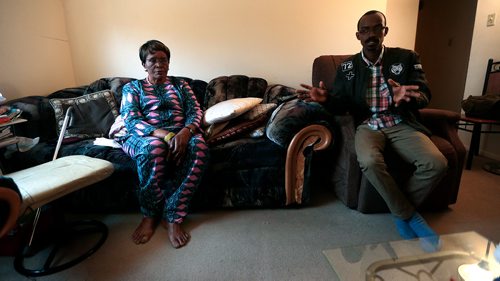 PHIL HOSSACK / WINNIPEG FREE PRESS - Louise-Marie Akiki sits in her St Boniface apartment during our interview her adopted son Steven aka Kasangaki Bigasaki translates. There is a darkness that never leaves her eyes. See Carol Sanders story. - April 11, 2019.