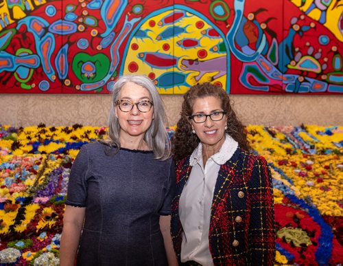 SASHA SEFTER / WINNIPEG FREE PRESS
Co-Chairs of the Art In Bloom committee Hazel Borys (left) and Hennie Corrin stand in-front of Artist Norval Morrisseau's mural "Androgyny" which has been replicated flowers by volunteers as for the Art In Bloom exhibit at the Winnipeg Art Gallery.190412 - Friday, April 12, 2019.