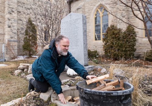 SASHA SEFTER / WINNIPEG FREE PRESS
FAITH - Reverend Paul Johnson of St. John's Cathedral sets up wood in a stone circle in preparation for the upcoming Easter fire.
190412 - Friday, April 12, 2019.