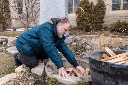 SASHA SEFTER / WINNIPEG FREE PRESS
FAITH - Reverend Paul Johnson of St. John's Cathedral sets up wood in a stone circle in preparation for the upcoming Easter fire.
190412 - Friday, April 12, 2019.