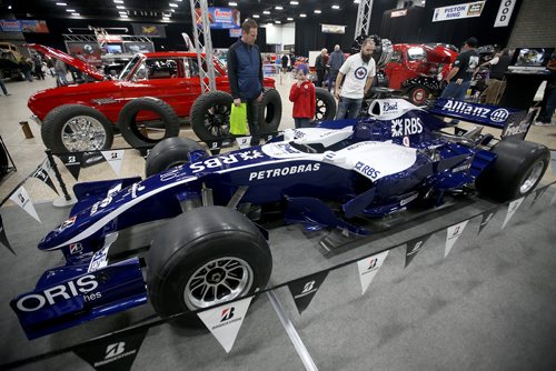 TREVOR HAGAN / WINNIPEG FREE PRESS
Doug Rapko and his son, Zayne, 7, and Chad Krastel check out a Formula 1 car used by Nico Rosberg in the 2006 season at the World of Wheels car show at the Convention Centre, Friday, April 12, 2019.
