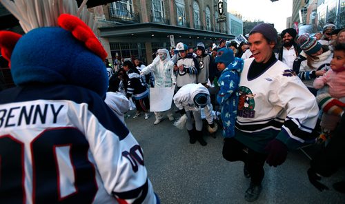 PHIL HOSSACK / WINNIPEG FREE PRESS - WHITE OUT PARTY-  Party fans dance with Benny on the streets outside the Bell/MTS Centre Friday. See Alex Paul's story. - April 12, 2019.