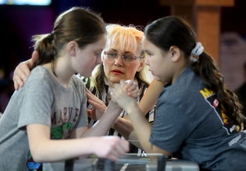 TREVOR HAGAN / WINNIPEG FREE PRESS
Jordan Espey versus Hannah Thomas with referee Jose Morneau during the age 9-10 left arm bracket at the Manitoba Provincial Arm Wrestling Championships at Canad Inns Polo Park, Saturday, April 13, 2019. Jordan would go on to win the category.