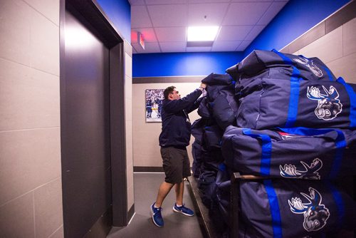 MIKAELA MACKENZIE / WINNIPEG FREE PRESS
Riley Kosmolak, visiting room attendant, piles bags of extra gear onto a cart on the Moose's last media day at the Bell MTS Iceplex in Winnipeg on Monday, April 15, 2019. 
Winnipeg Free Press 2019.