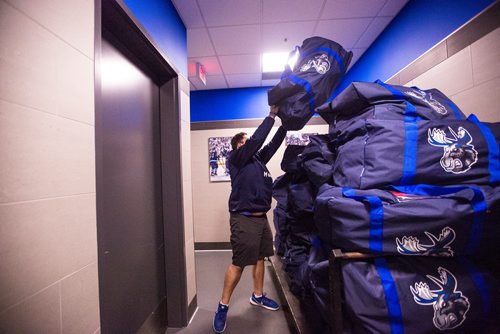 MIKAELA MACKENZIE / WINNIPEG FREE PRESS
Riley Kosmolak, visiting room attendant, piles bags of extra gear onto a cart on the Moose's last media day at the Bell MTS Iceplex in Winnipeg on Monday, April 15, 2019. 
Winnipeg Free Press 2019.