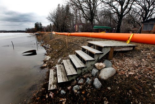 PHIL HOSSACK / WINNIPEG FREE PRESS -  Tiger dikes top up an earth  berm to prevent flooding along Netley Creek Monday. An ice  jam on the Red River sent creek levels up fast overnight, municipal officials placed tiger dykes and raised at least one road to protect most homes.  April 15, 2019.