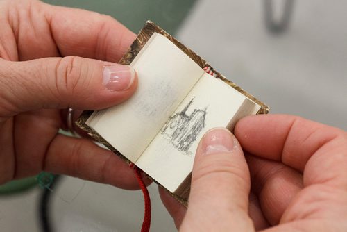 MIKE DEAL / WINNIPEG FREE PRESS
Artist Wanda Koop in her Winnipeg Studio with one of the ten sketch books she carried with her that she filled with drawings of the Notre Dame Cathedral during her six-month Canada Council Paris Studio trip.
190416 - Tuesday, April 16, 2019.