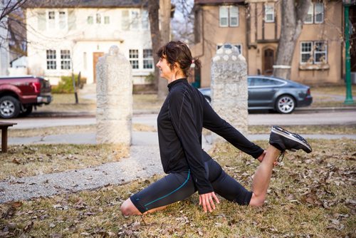 MIKAELA MACKENZIE/WINNIPEG FREE PRESS
Avid runner Sylvia Buchholz does a pigeon pose stretch before running to work in Winnipeg on Wednesday, April 17, 2019. 
Winnipeg Free Press 2019