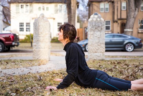 MIKAELA MACKENZIE/WINNIPEG FREE PRESS
Avid runner Sylvia Buchholz does a sun salutation before running to work in Winnipeg on Wednesday, April 17, 2019. 
Winnipeg Free Press 2019