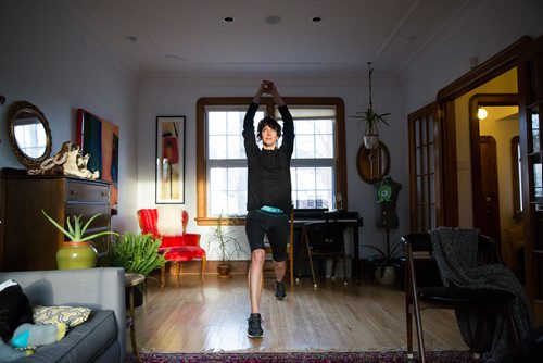 MIKAELA MACKENZIE/WINNIPEG FREE PRESS
Avid runner Sylvia Buchholz does a sun salutation before running to work in Winnipeg on Wednesday, April 17, 2019. 
Winnipeg Free Press 2019