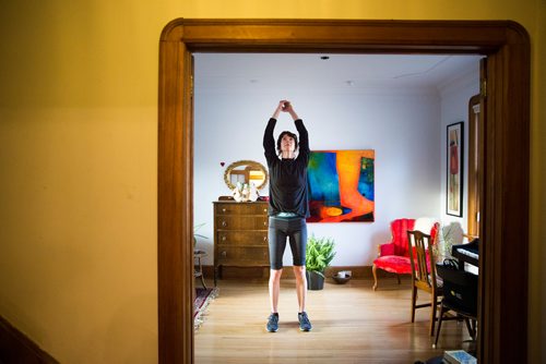 MIKAELA MACKENZIE/WINNIPEG FREE PRESS
Avid runner Sylvia Buchholz does a sun salutation before running to work in Winnipeg on Wednesday, April 17, 2019. 
Winnipeg Free Press 2019