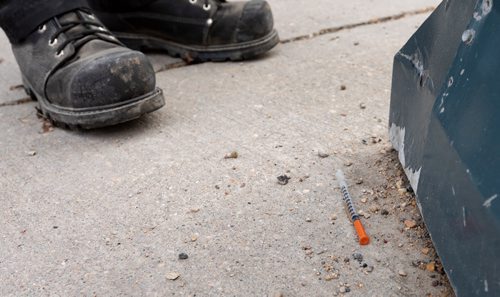 SASHA SEFTER / WINNIPEG FREE PRESS
General Maintenance worker James Turner of Downtown BIZ's Enviro Team collects a syringe from the grounds of St Mary's Cathedral and disposes of it safely on St Mary Avenue in downtown Winnipeg. See Declan Schroeder story.
190417 - Wednesday, April 17, 2019.