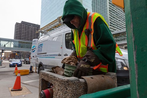 SASHA SEFTER / WINNIPEG FREE PRESS
General Maintenance worker James Turner of Downtown BIZ's Enviro empties his garbage pale into a trash can at the intersection of St Mary Avenue and Hargrave Street in downtown Winnipeg. See Declan Schroeder story.
190417 - Wednesday, April 17, 2019.