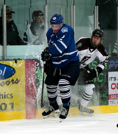 PHIL HOSSACK / WINNIPEG FREE PRESS - St James Canuck #2 Adam Thurlbeck and Pembina Valley Twister #16 Nico Vigier slam into the boards in a spray of ice with the puck Wednesday evening in Morris MMJHL Playoff action. - April 17, 2019.