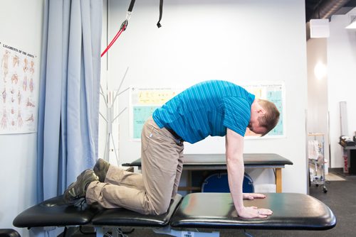 MIKAELA MACKENZIE/WINNIPEG FREE PRESS
Physiotherapist Gilbert Magne demonstrates cat/camel stretches at Precision Movement & Therapies clinic in Winnipeg on Thursday, April 18, 2019. 
Winnipeg Free Press 2019