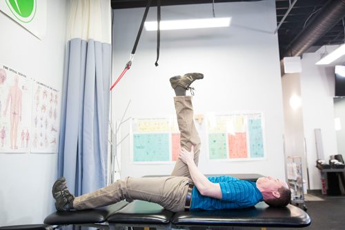 MIKAELA MACKENZIE/WINNIPEG FREE PRESS
Physiotherapist Gilbert Magne demonstrates leg raise stretch at Precision Movement & Therapies clinic in Winnipeg on Thursday, April 18, 2019. 
Winnipeg Free Press 2019