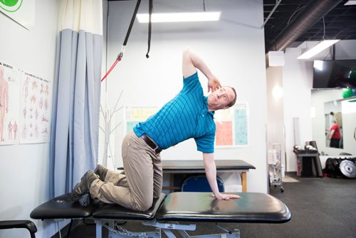 MIKAELA MACKENZIE/WINNIPEG FREE PRESS
Physiotherapist Gilbert Magne demonstrates a chest opener stretch at Precision Movement & Therapies clinic in Winnipeg on Thursday, April 18, 2019. 
Winnipeg Free Press 2019