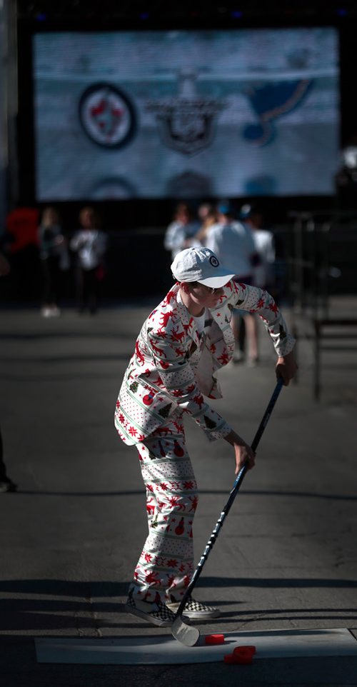 PHIL HOSSACK / WINNIPEG FREE PRESS - Aiming for another win a fan fires pucks at a shootout target Thursday as fans arrived for festivities. - April 18, 2019.