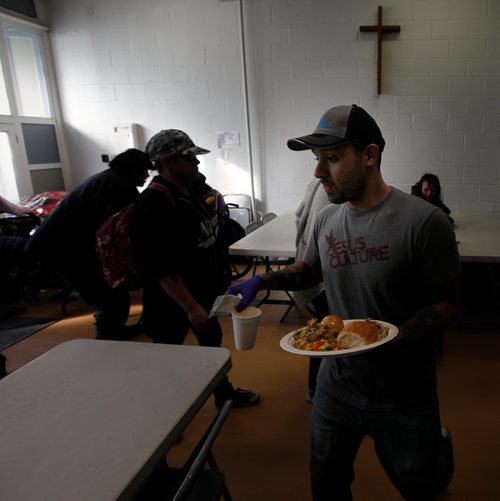 PHIL HOSSACK / WINNIPEG FREE PRESS - Volunteer 'Donald' delivers a plate of turkey and mashed potato to some disabled who cannot stand in line with 300 plus 'patrons' at the LightHouse Mission on Main street for a traditional Good Friday holiday meal. See release.  - April 19, 2019.