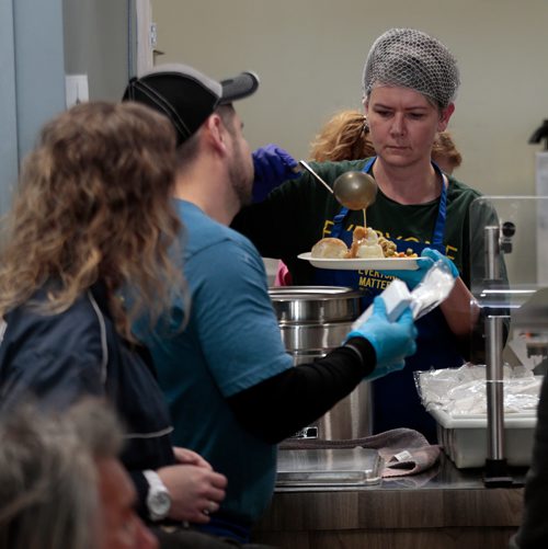 PHIL HOSSACK / WINNIPEG FREE PRESS - Volunteers put gravy on potatoes as they seerve 300 plus 'patrons' at the LightHouse Mission on Main street for a traditional Good Friday holiday meal. See release.  - April 19, 2019.